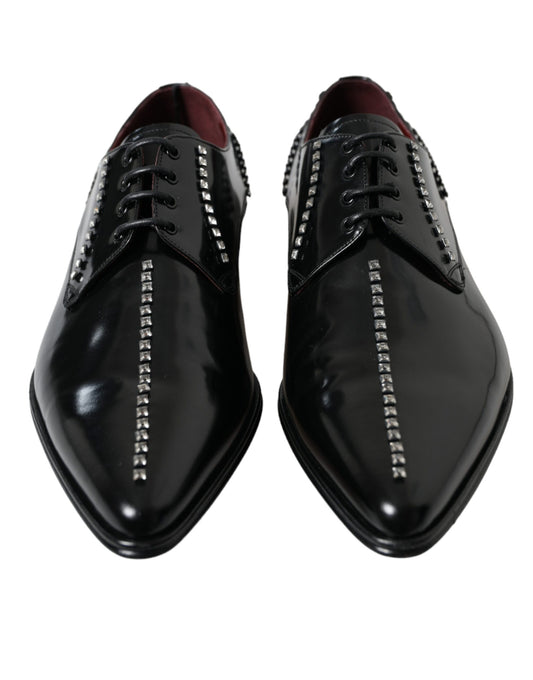Pair of black dress shoes with silver studs on laces