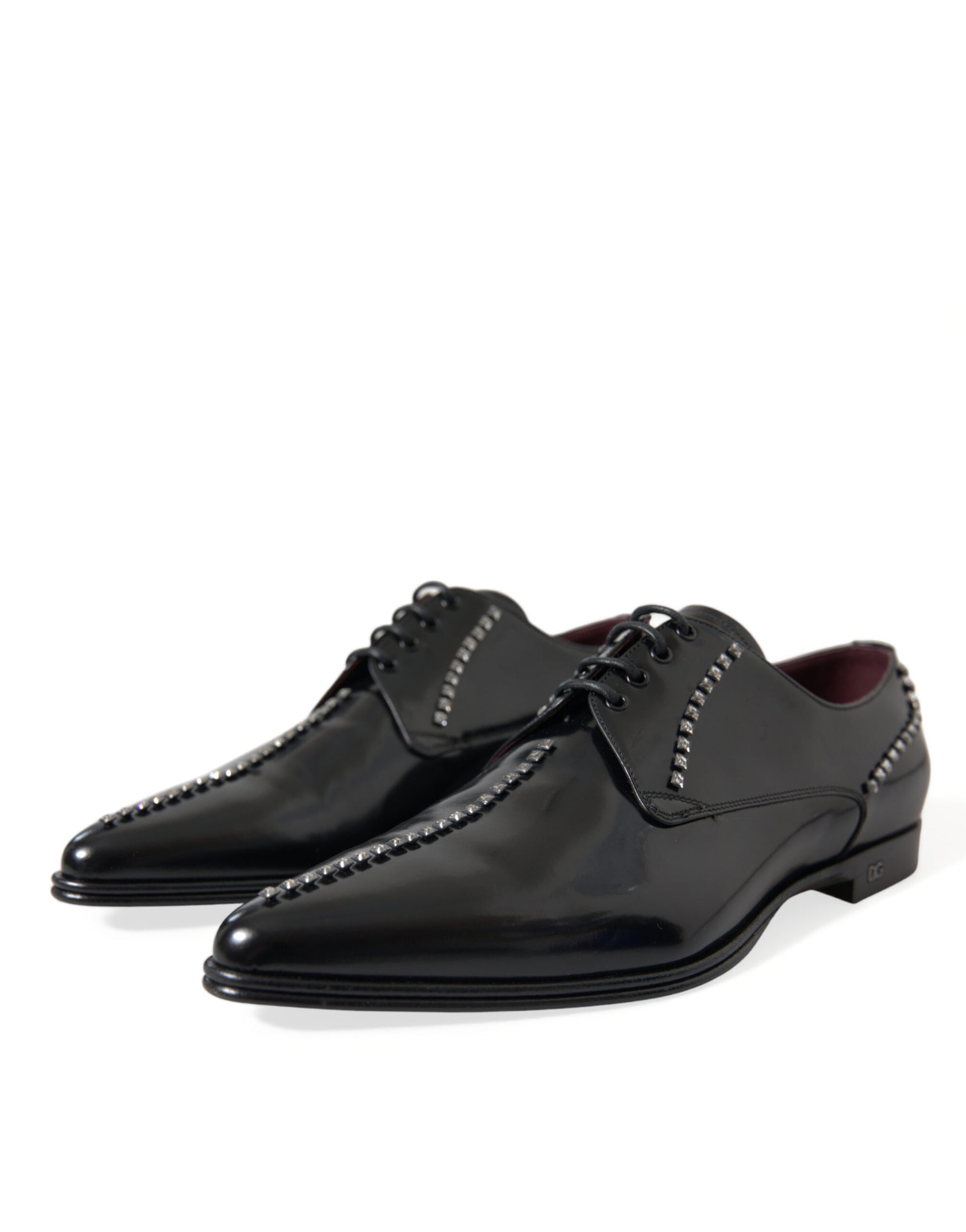 Pair of black dress shoes with laces and studs on soles