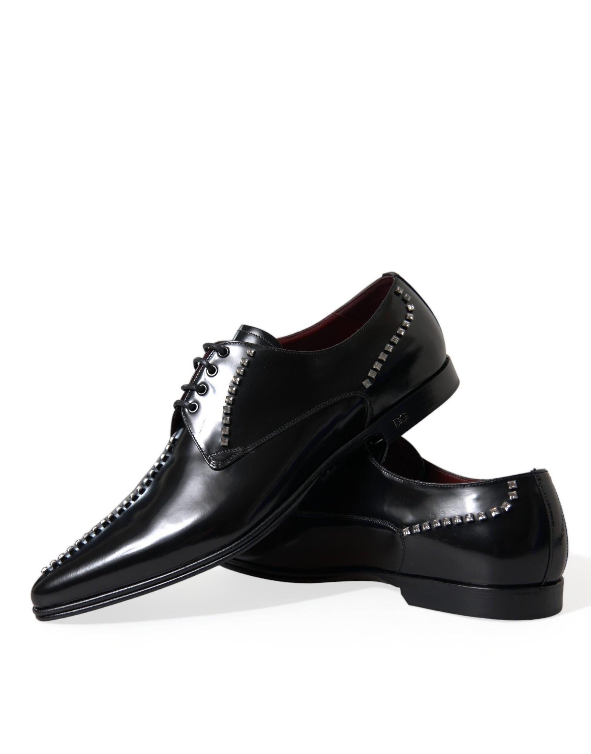 Pair of black dress shoes with silver studs on sides