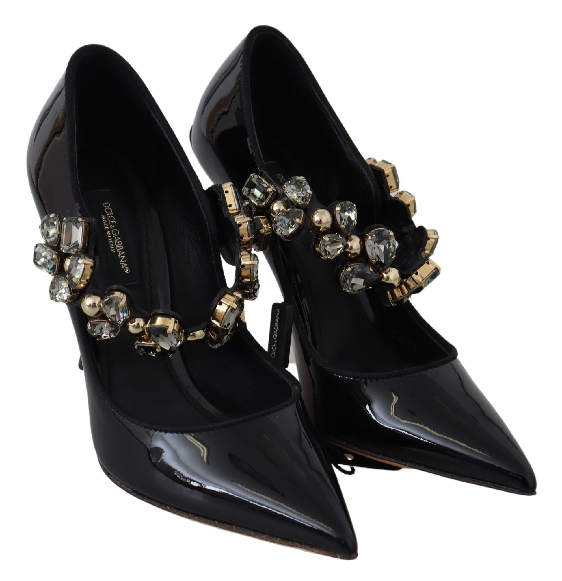 Pair of black high heel shoes with gold embellishments and a strap across the foot