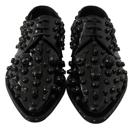 Pair of black shoes with round studs on top and sides