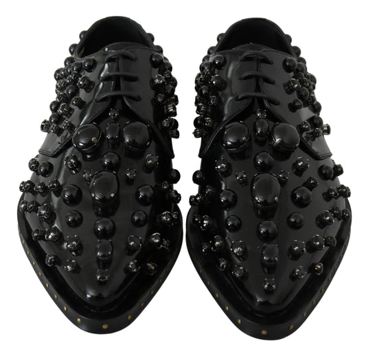 Pair of black shoes with round studs on top and sides