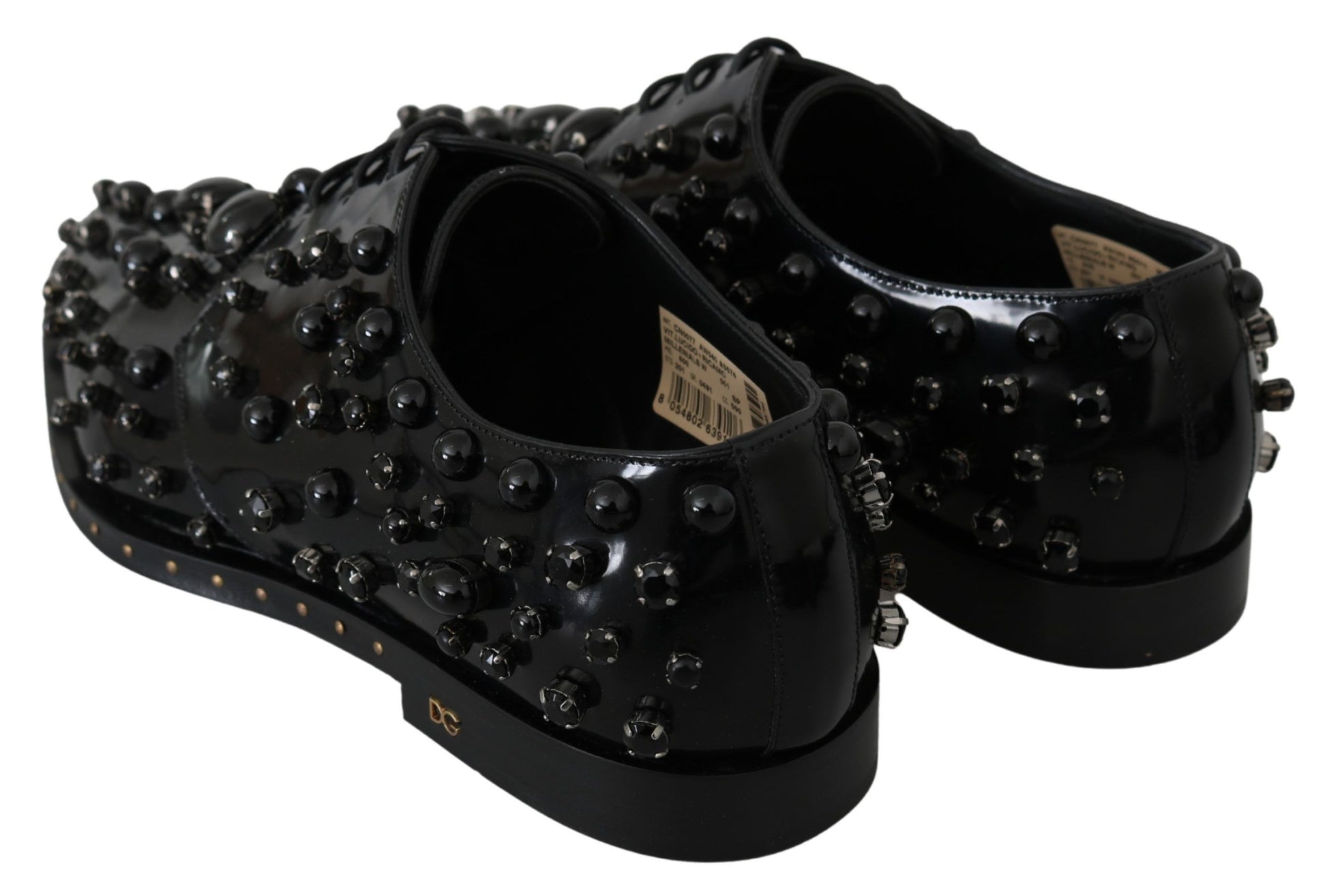 Pair of black shoes with studs and a label on the tongue