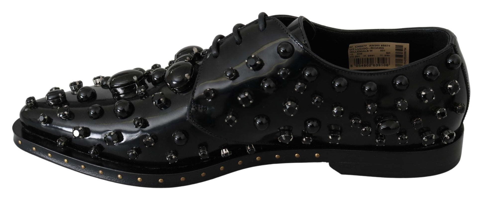 Black shoe with multiple studs on top and bottom