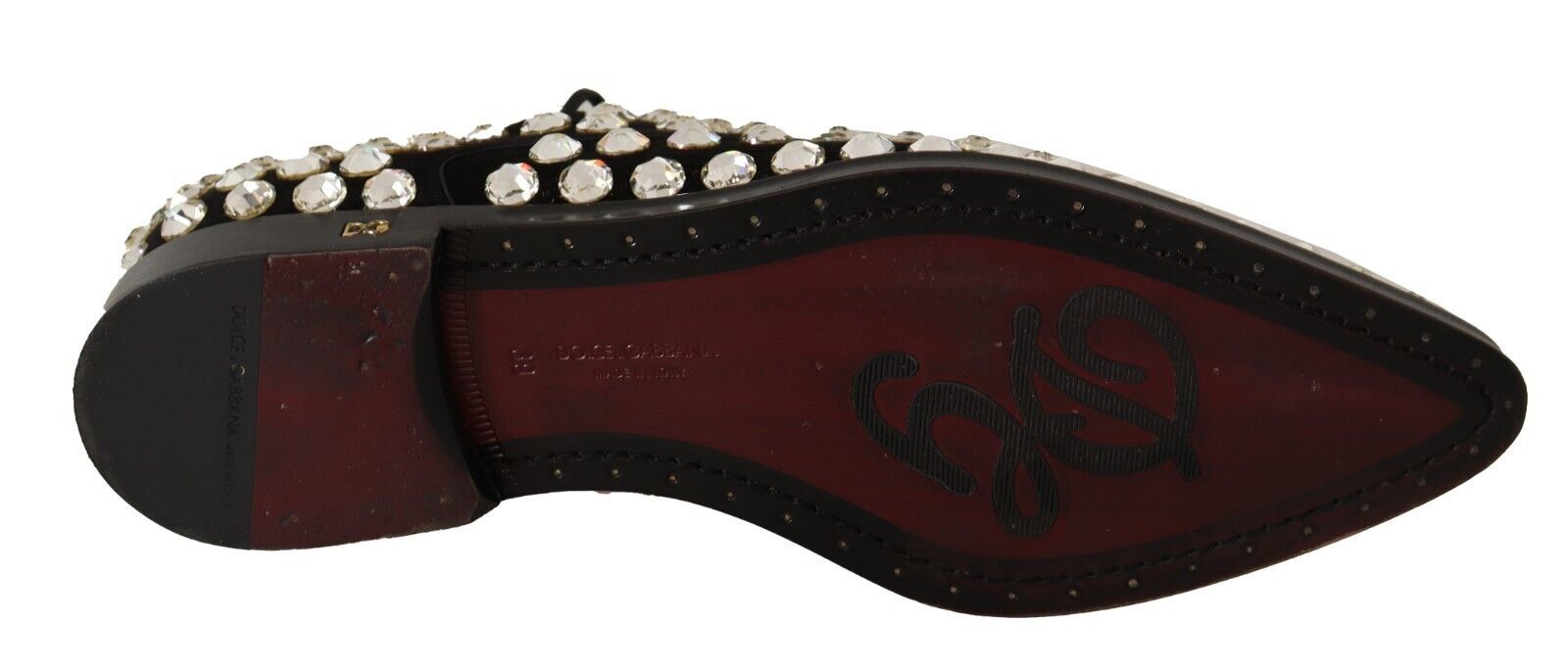 A single shoe against a neutral background. It appears to be a women's flat with a pointed toe and a strap across the top
