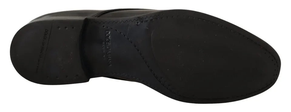 A pair of black leather dress shoes with a derby style, featuring a lace-up front and a low heel