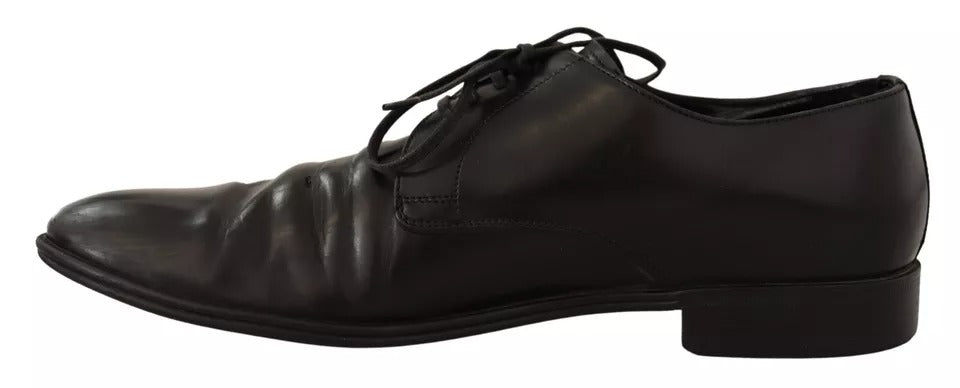 Pair of black leather dress shoes with laces, featuring a derby style and a shiny finish