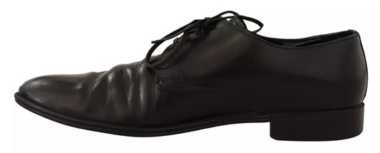 Pair of black leather dress shoes with laces, featuring a derby style and a shiny finish