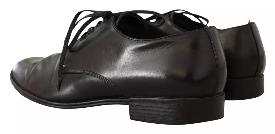 Pair of black leather dress shoes with laces, featuring a derby style and a low heel