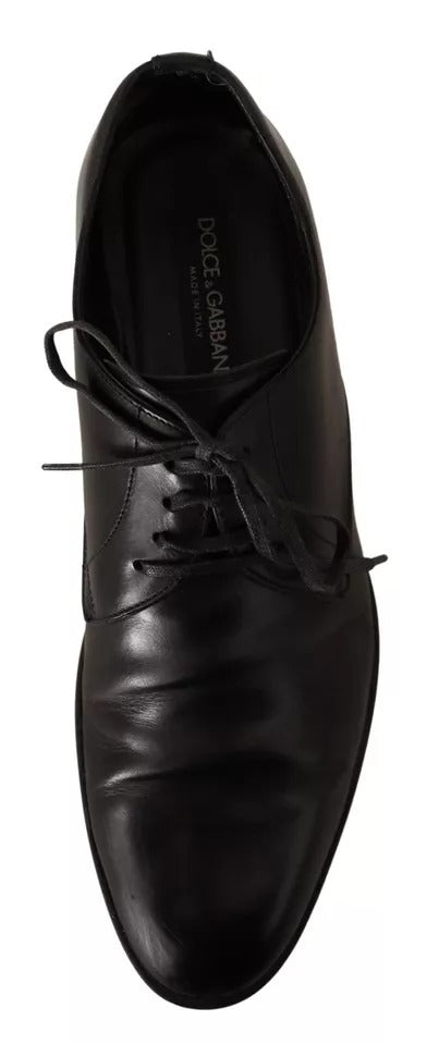 A pair of black leather dress shoes with laces, featuring a classic derby design and a subtle brand logo on the side