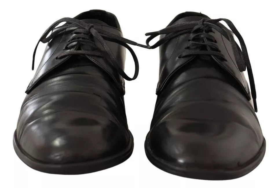 Pair of black leather dress shoes with laces, featuring a shiny finish and a classic derby design