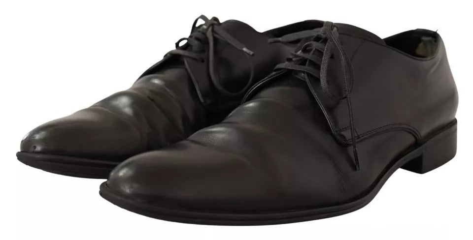 Pair of black leather dress shoes with laces, featuring a derby style and a shiny finish