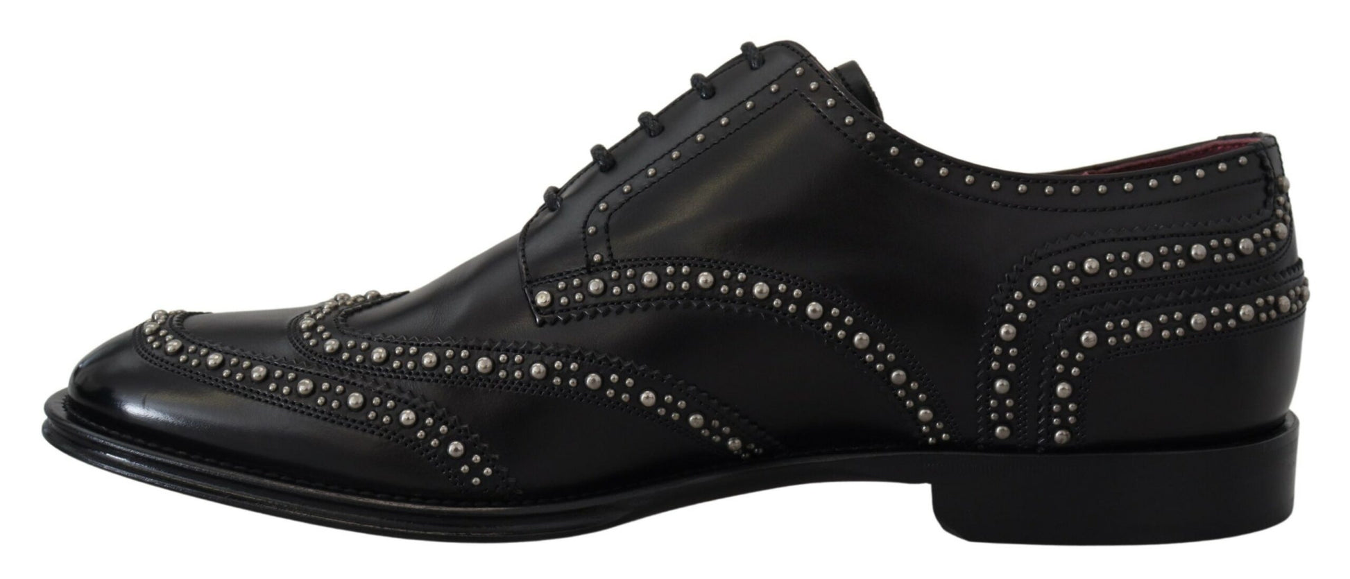 A pair of black leather derby shoes with studs and a bow tie design on the toe