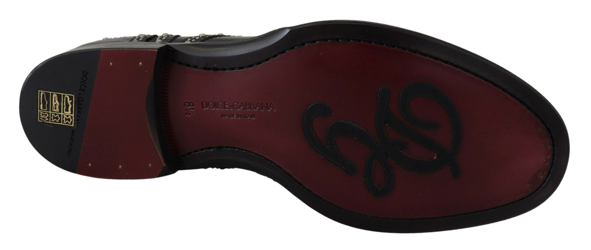 A pair of black leather dress shoes with studs, featuring a red sole and the brand name on the side