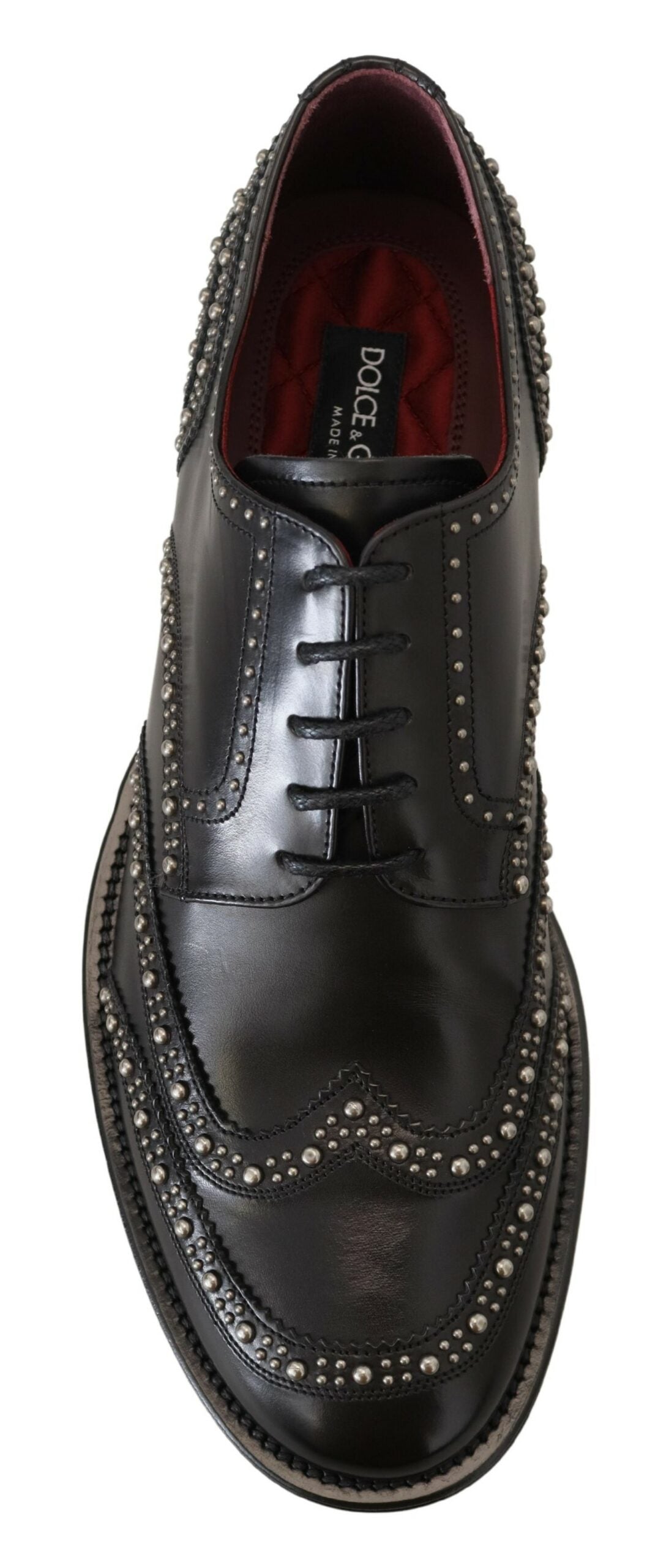 A pair of black leather dress shoes with studded detailing and a red lining, by Dolce & Gabbana