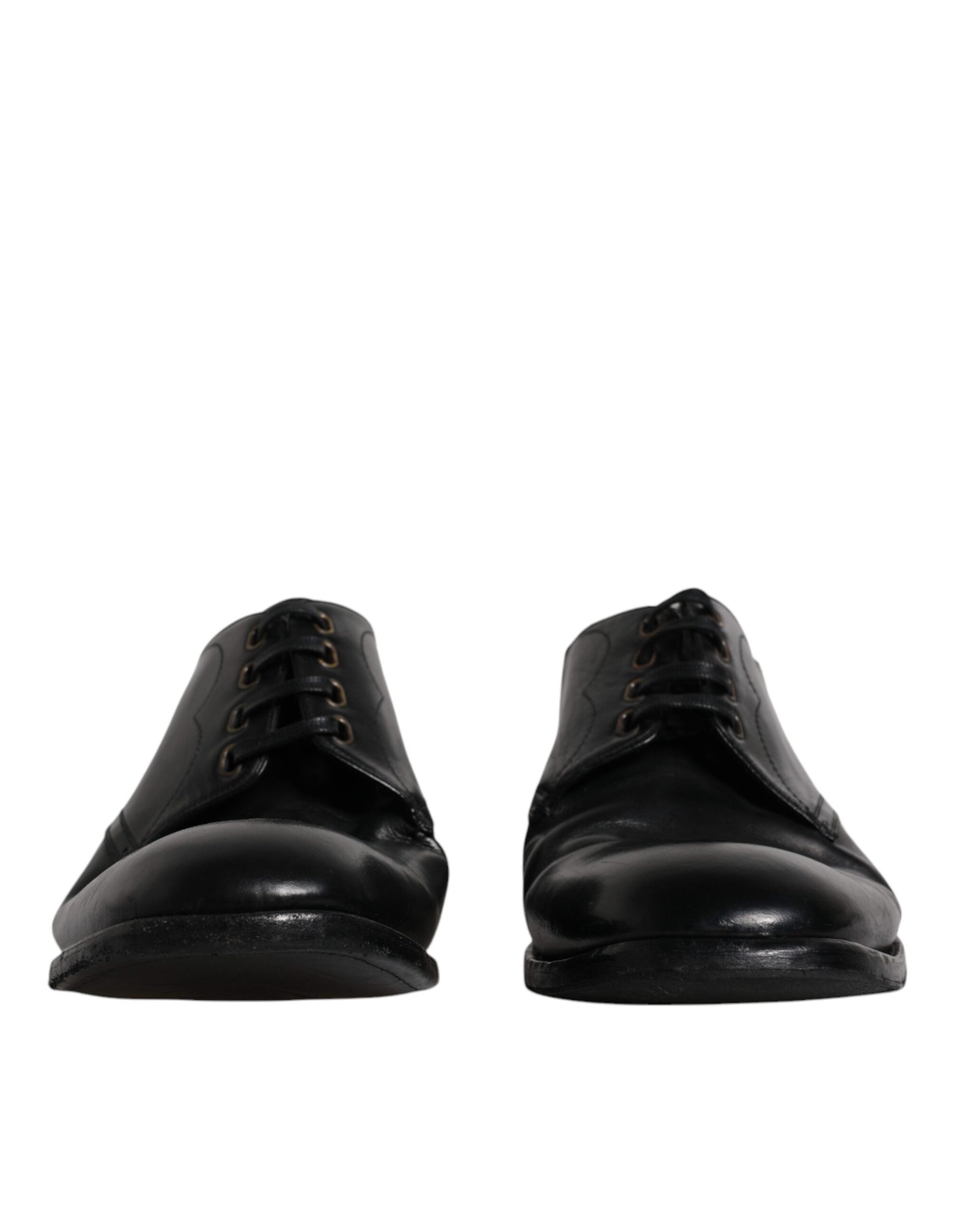 Pair of black leather dress shoes with laces and a shiny finish