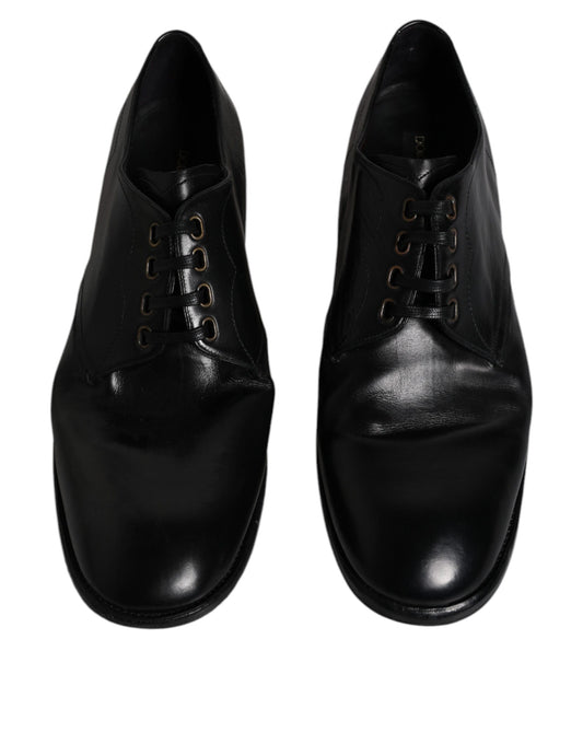 Pair of black leather dress shoes with laces and gold accents, designed by Dolce & Gabbana