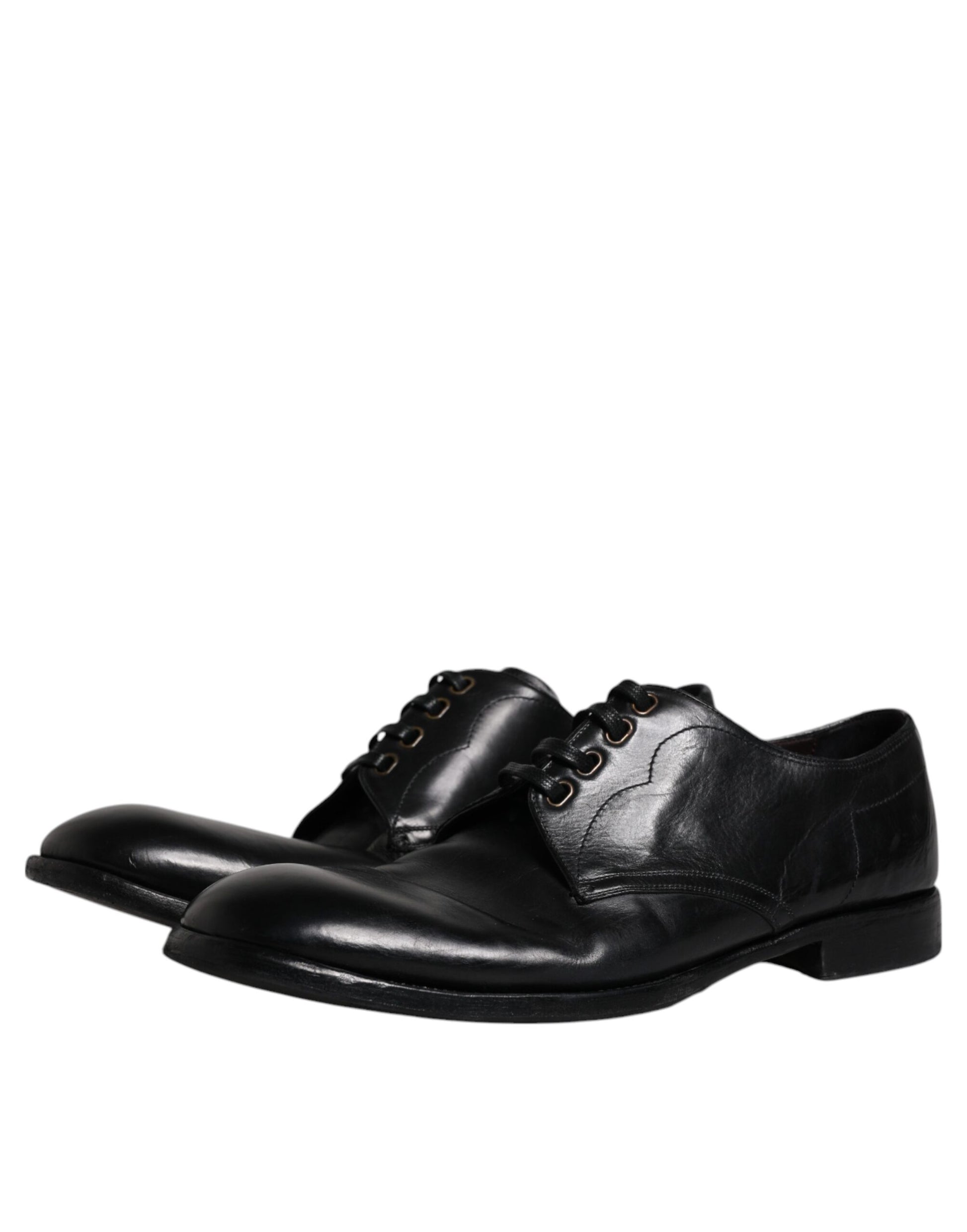 Pair of black leather dress shoes with laces and buckles, featuring a derby style