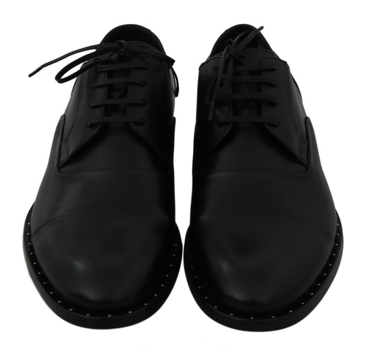 Pair of black leather shoes with laces and stitching details