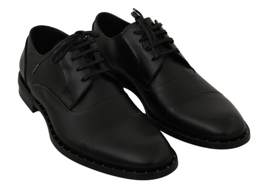 Pair of black dress shoes with laces and a small heel