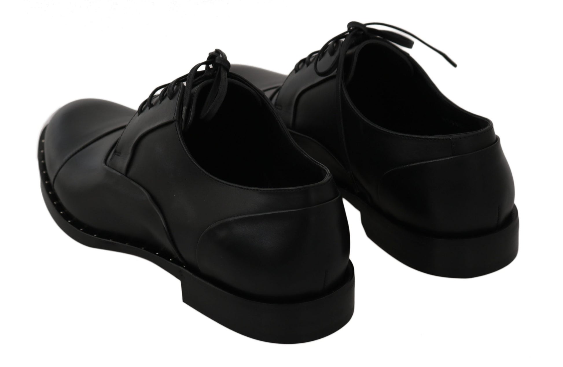 Pair of black leather shoes with laces and a bow on top