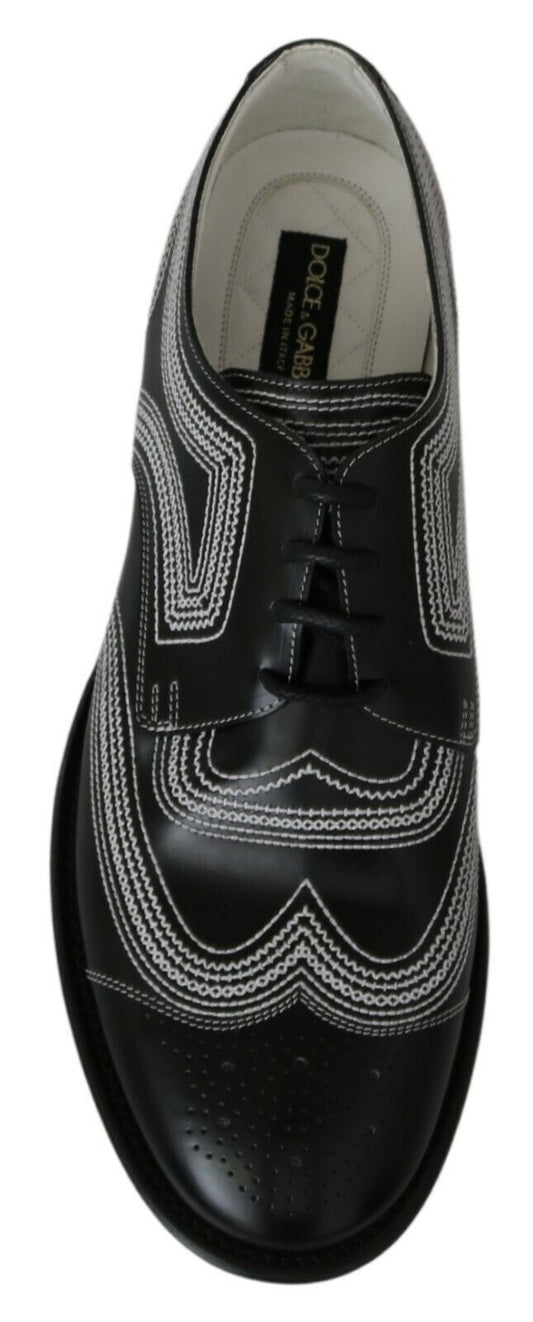 Black shoe with white laces and a patterned design on the side