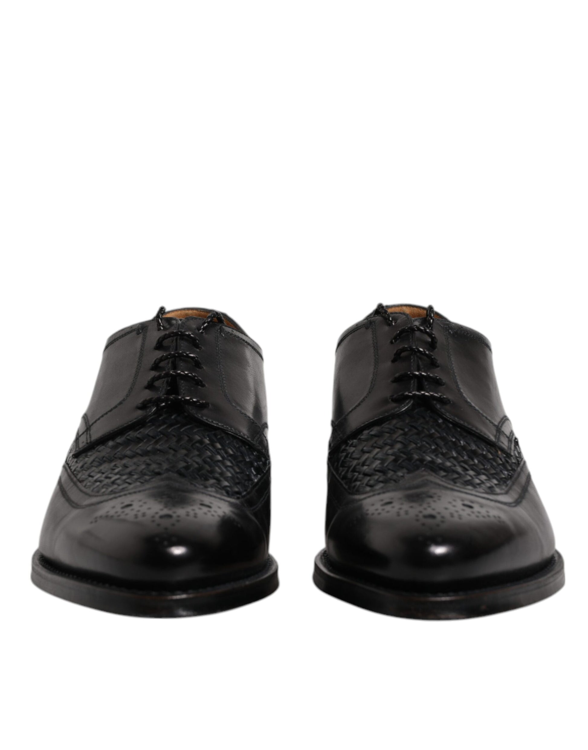Pair of black leather dress shoes with laces, wingtip design and a shiny finish