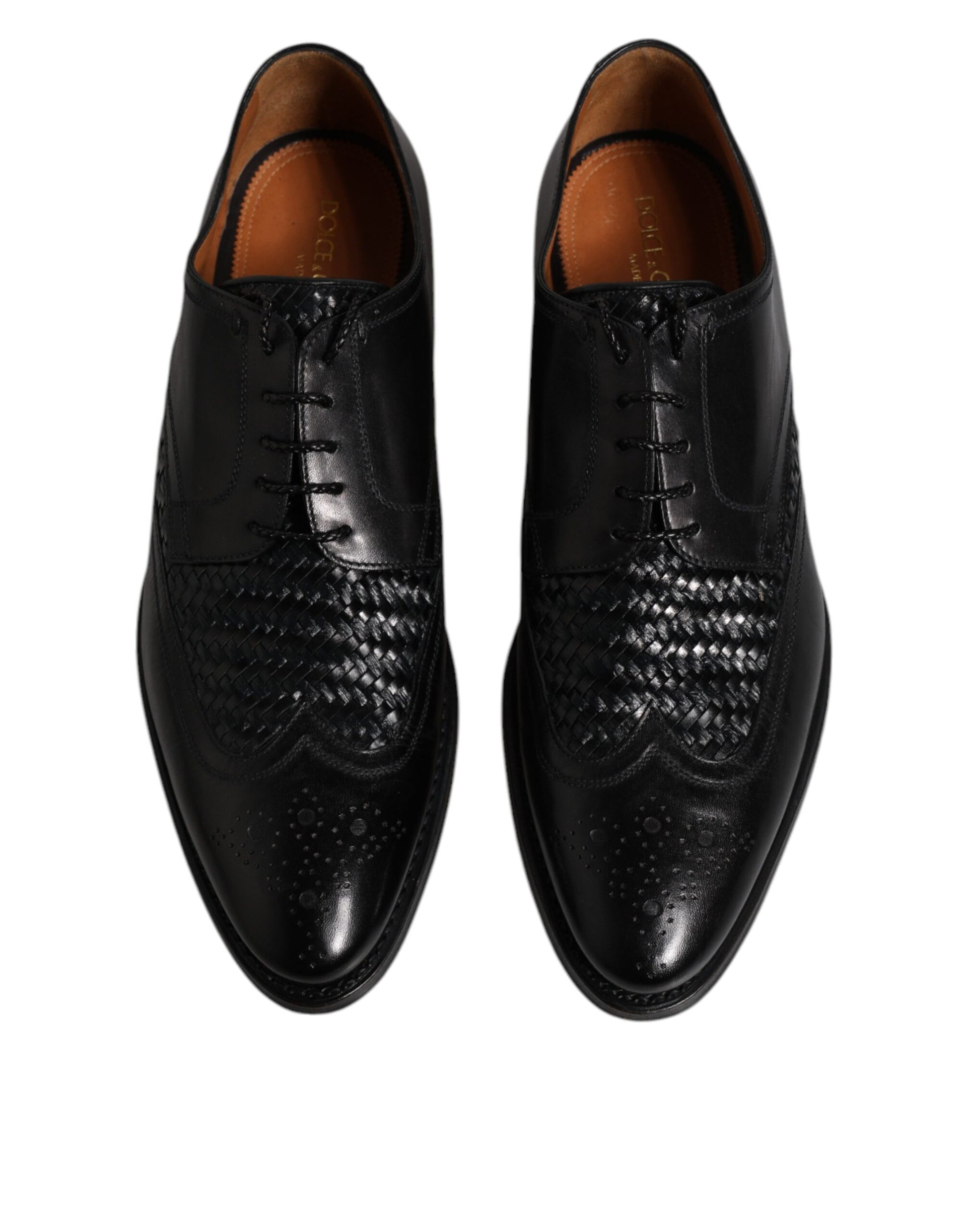 Pair of black leather dress shoes with laces and wingtip design