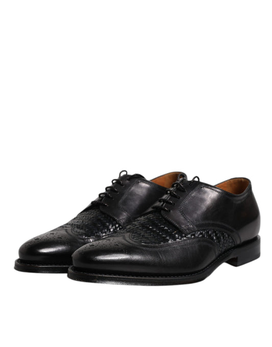 Pair of black leather dress shoes with laces, wingtip design and embossed logo