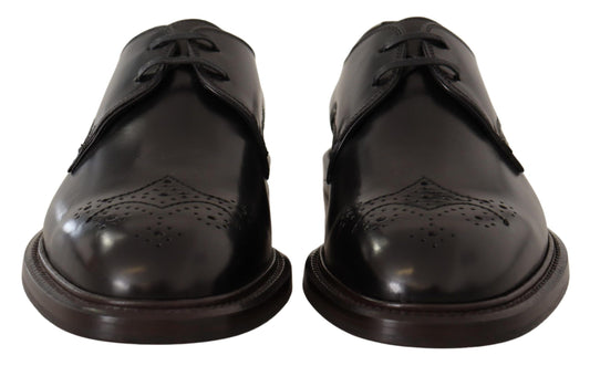 Pair of black leather dress shoes with laces and a bow tie design on top