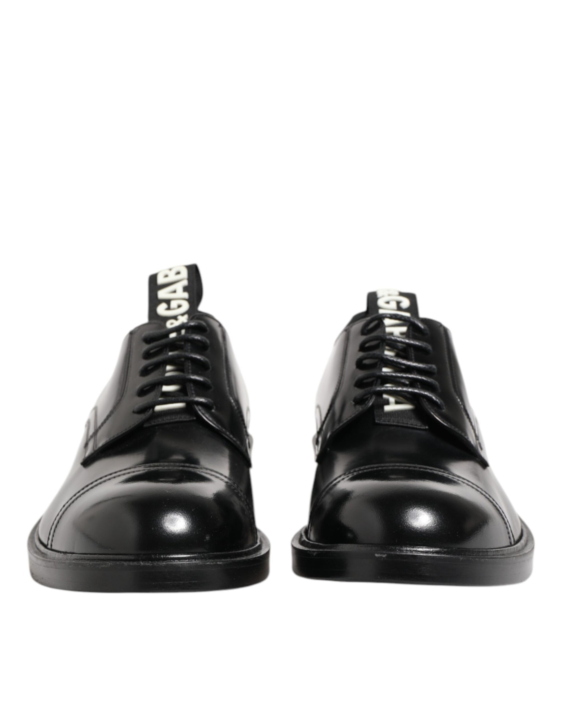 Pair of black leather lace-up shoes with silver buckles, designed by Dolce & Gabbana