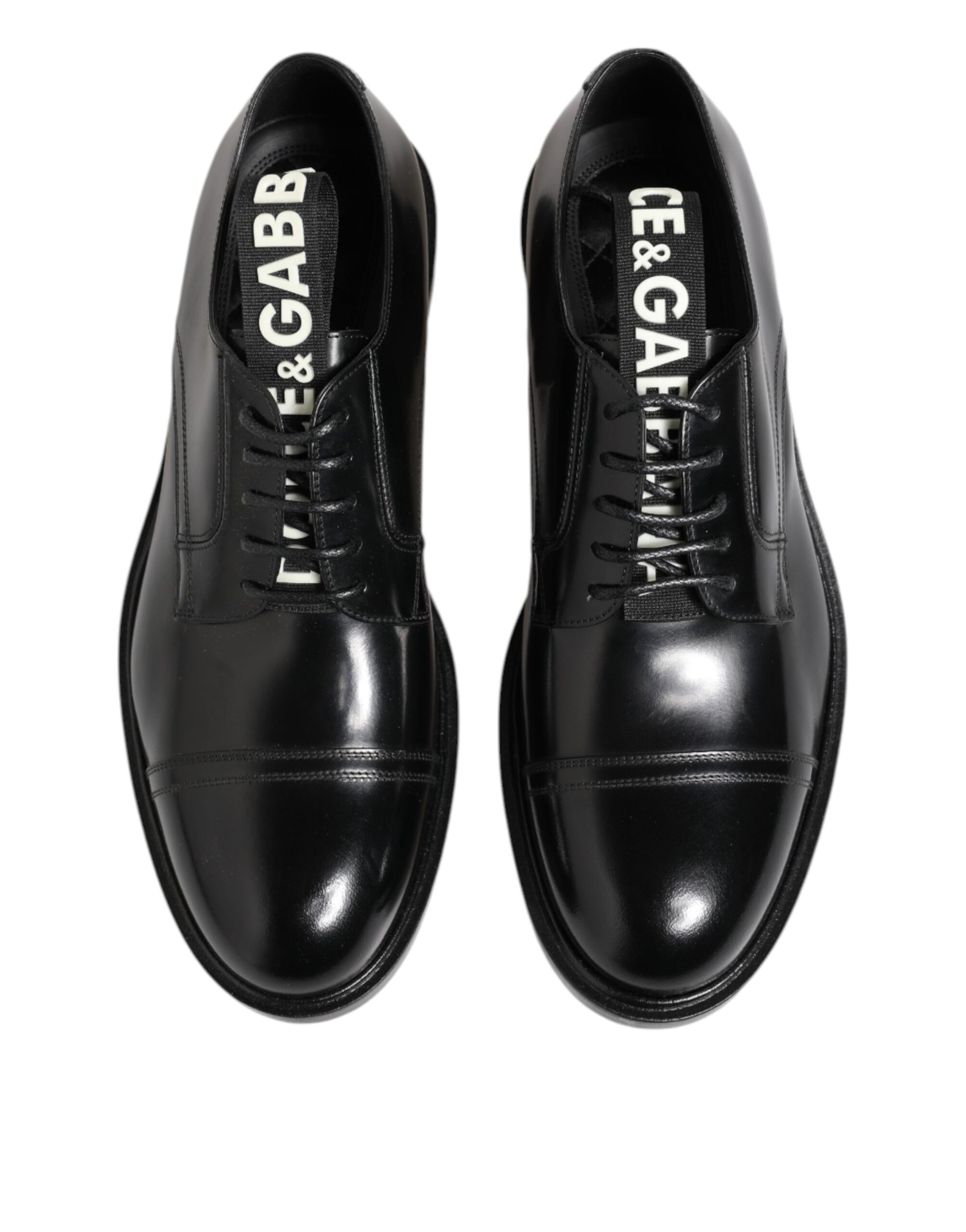 Pair of black leather dress shoes with laces, featuring the brand name "Dolce & Gabbana" on the side