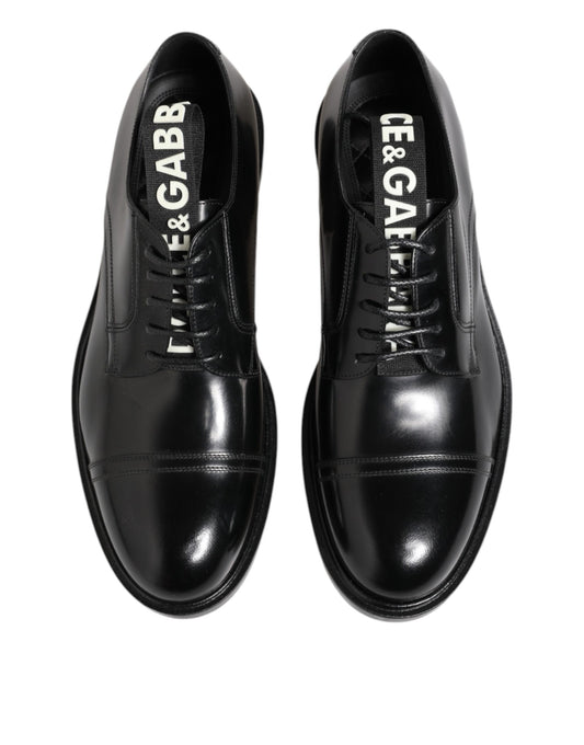 Pair of black leather dress shoes with laces, featuring the brand name "Dolce & Gabbana" on the side