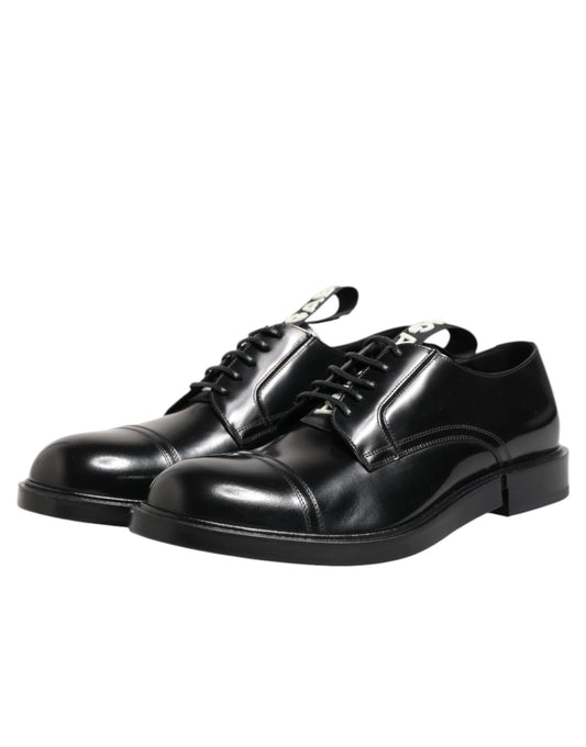 A pair of black leather dress shoes with laces, featuring a shiny finish and a classic design