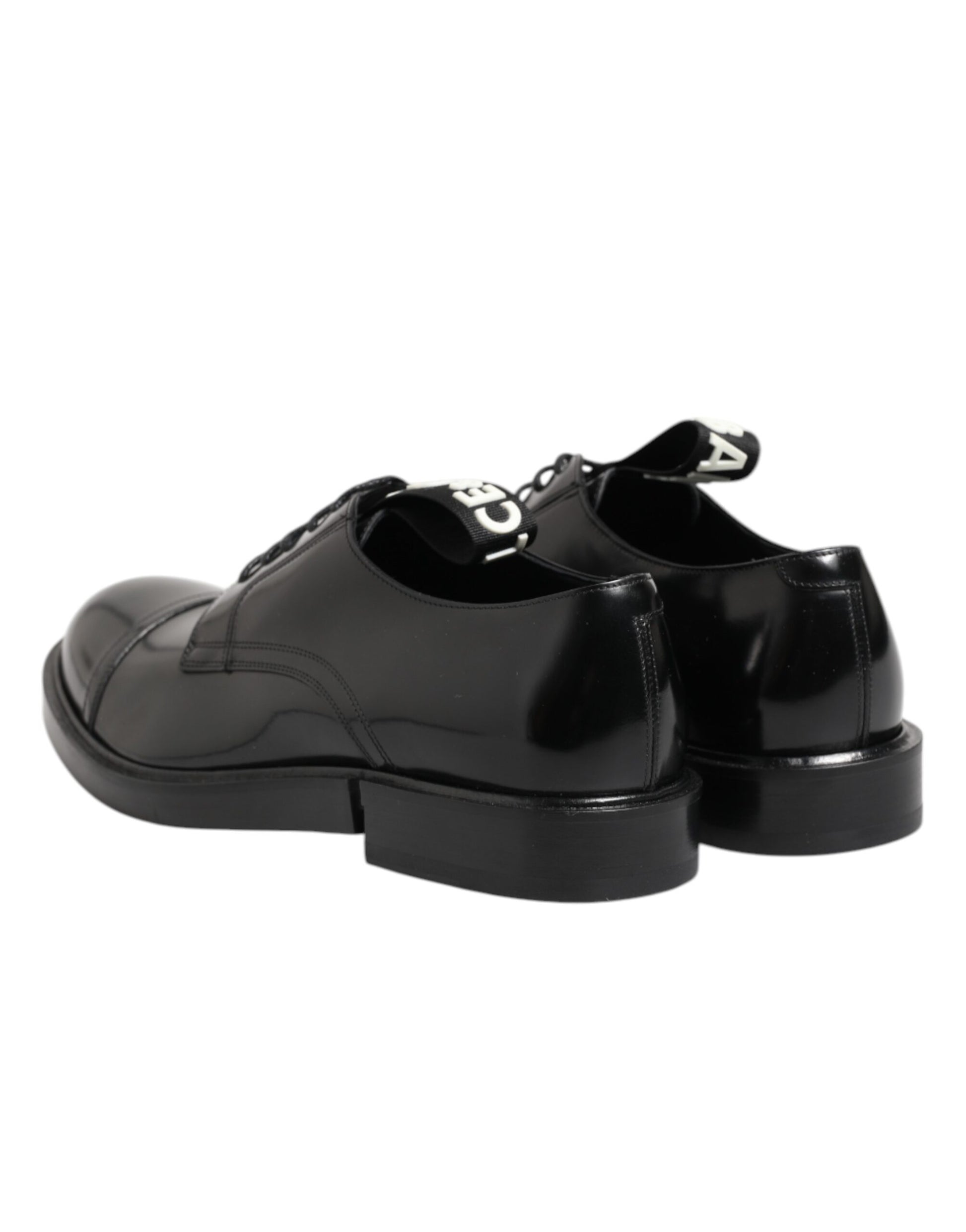 A pair of black leather dress shoes with laces, featuring a shiny finish and chunky soles