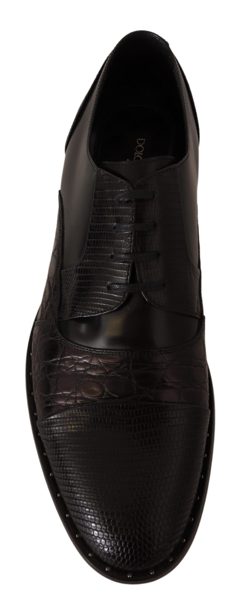 Black leather shoe with stitched detailing and a pointed toe