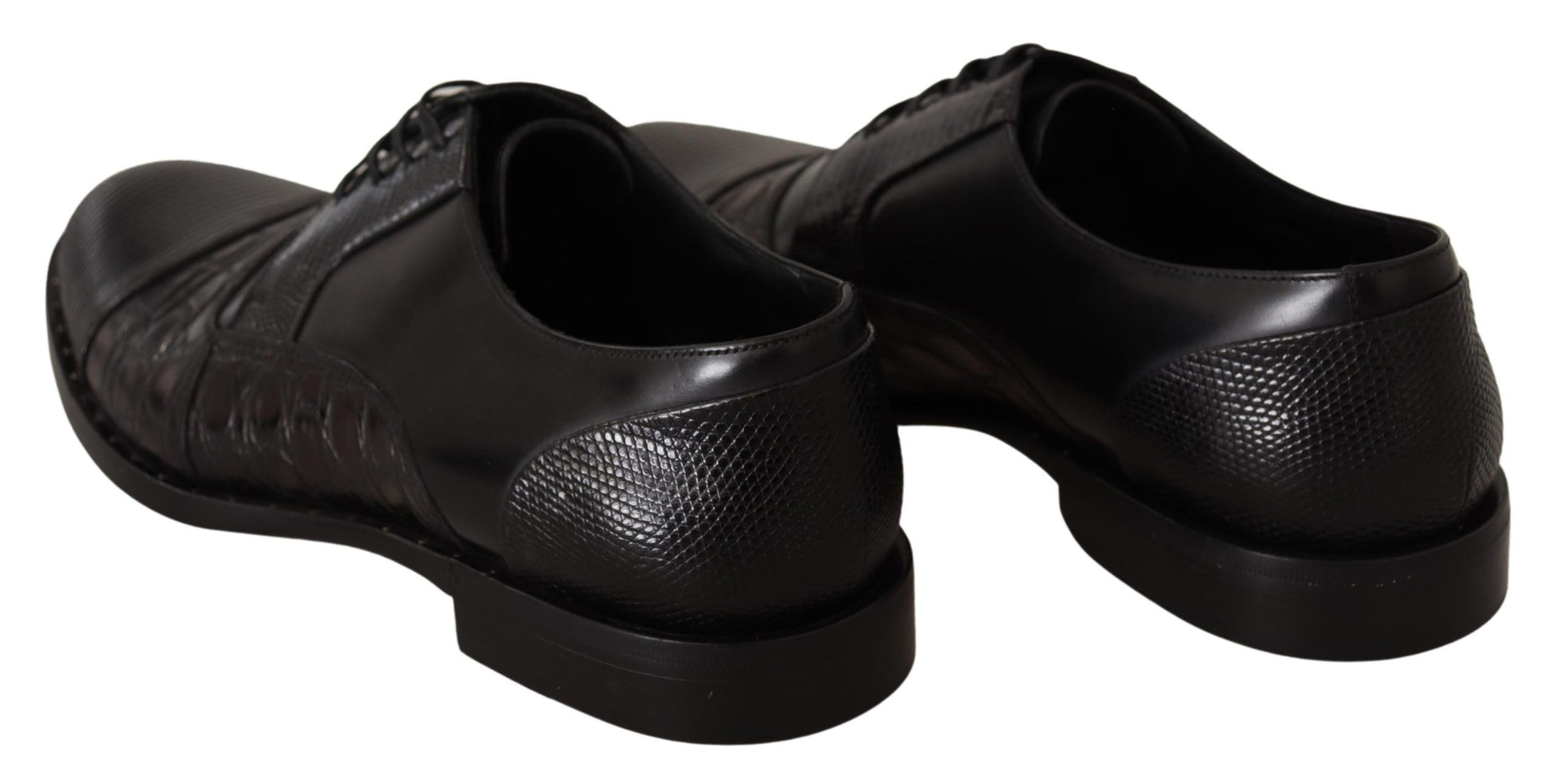 Pair of black dress shoes with laces and a shiny texture on the upper part