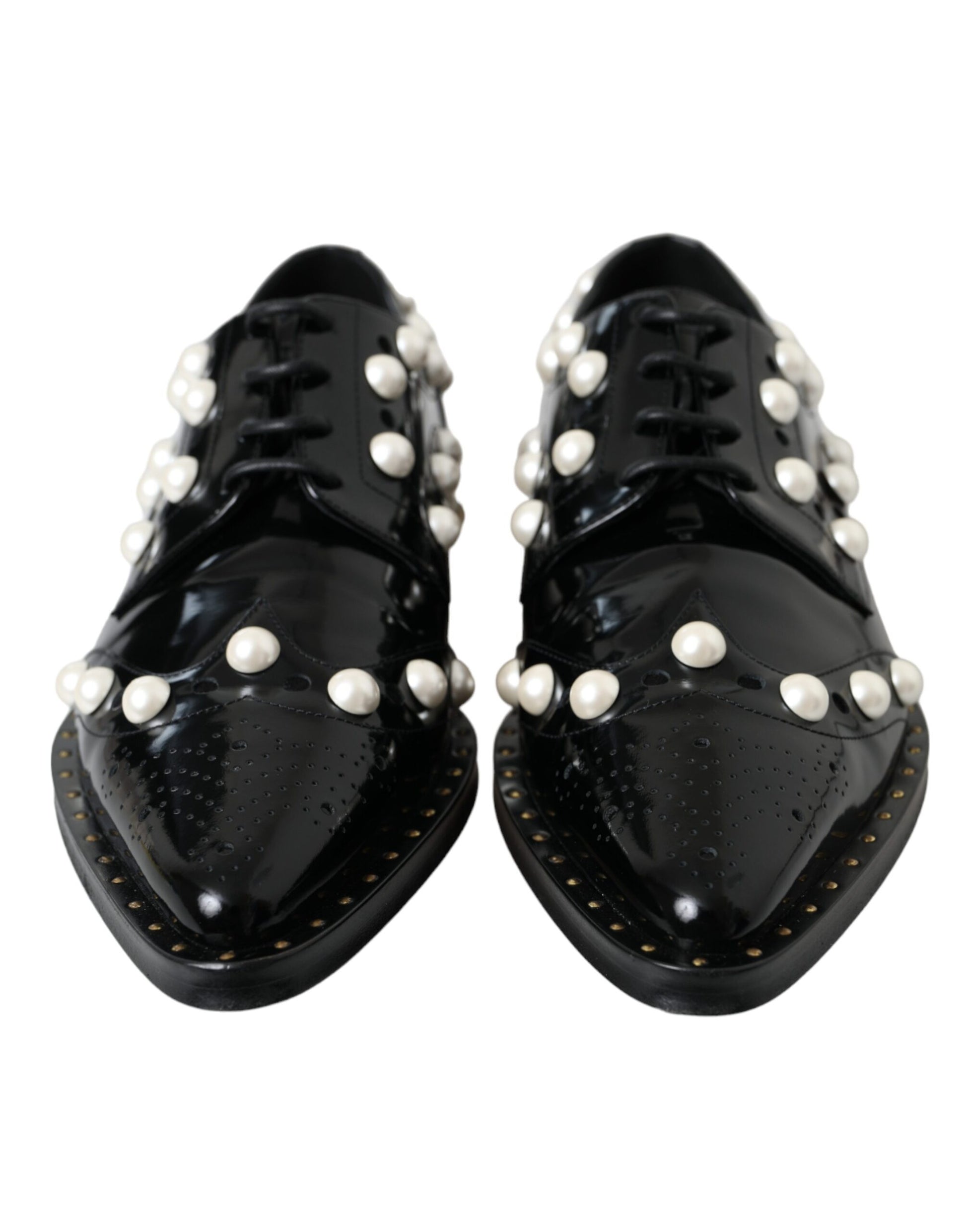 Pair of black leather shoes with faux pearls and gold accents