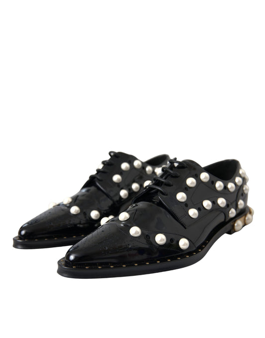 Pair of black leather shoes with faux pearls and a brogue design