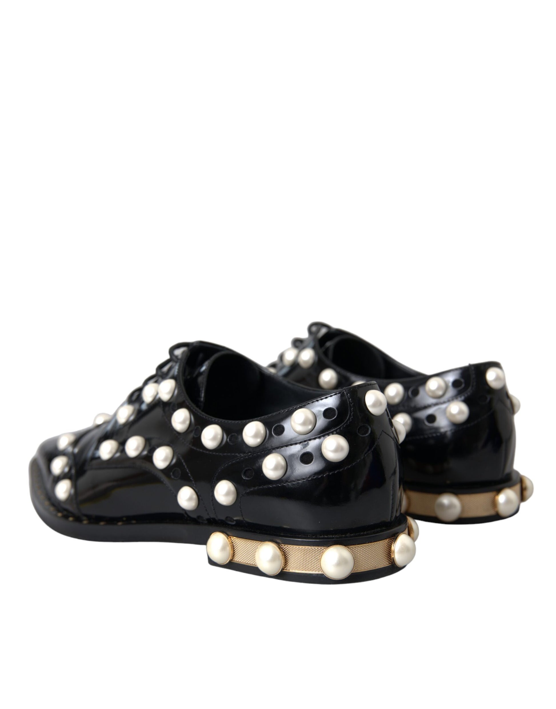 Pair of black leather shoes with faux pearls and gold accents