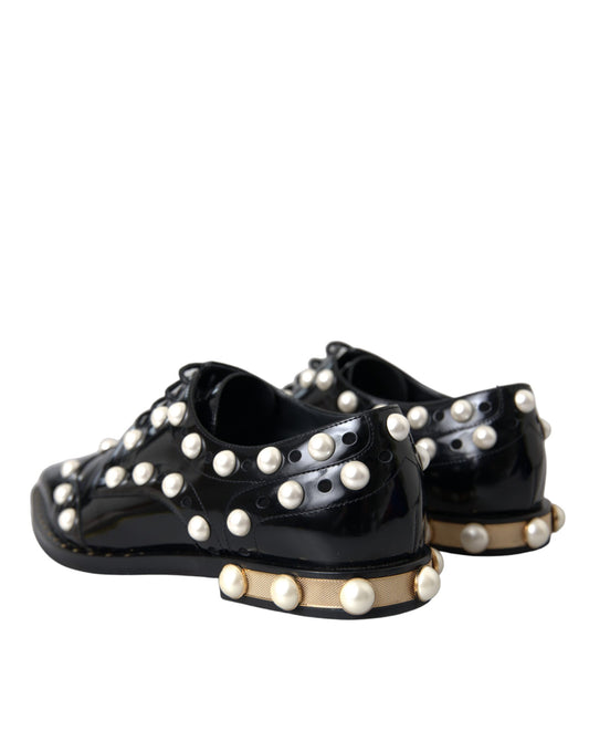 Pair of black leather shoes with faux pearls and gold accents