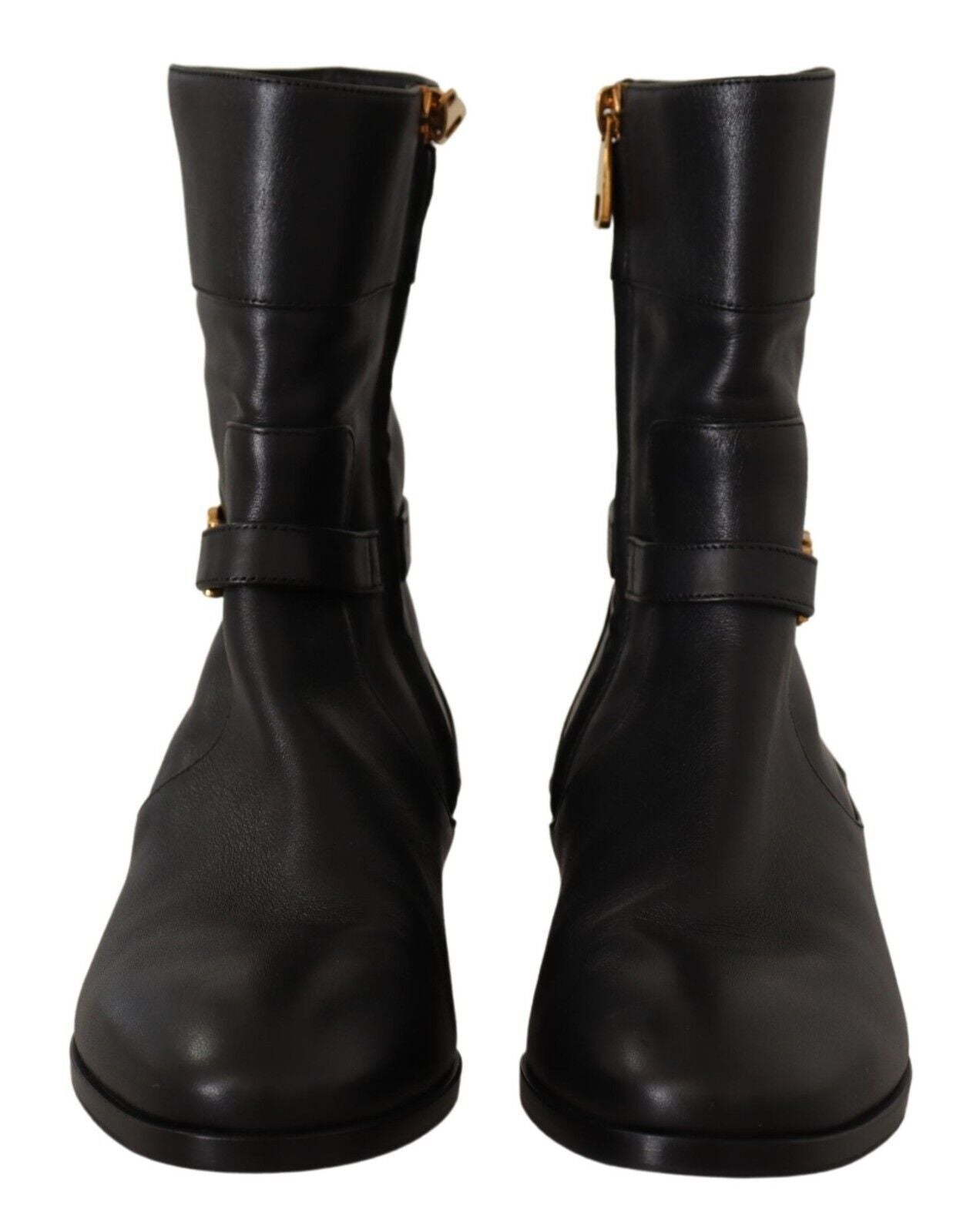 Pair of black leather boots with gold buckles and straps
