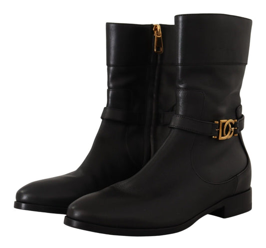 Pair of black leather boots with gold buckle and heel