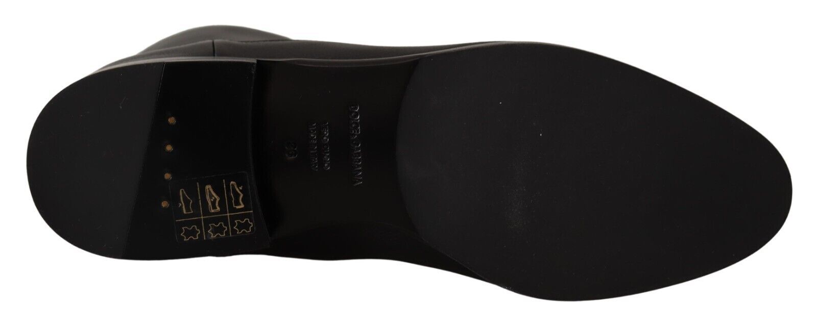 Black shoe with gold accents and a bow on top