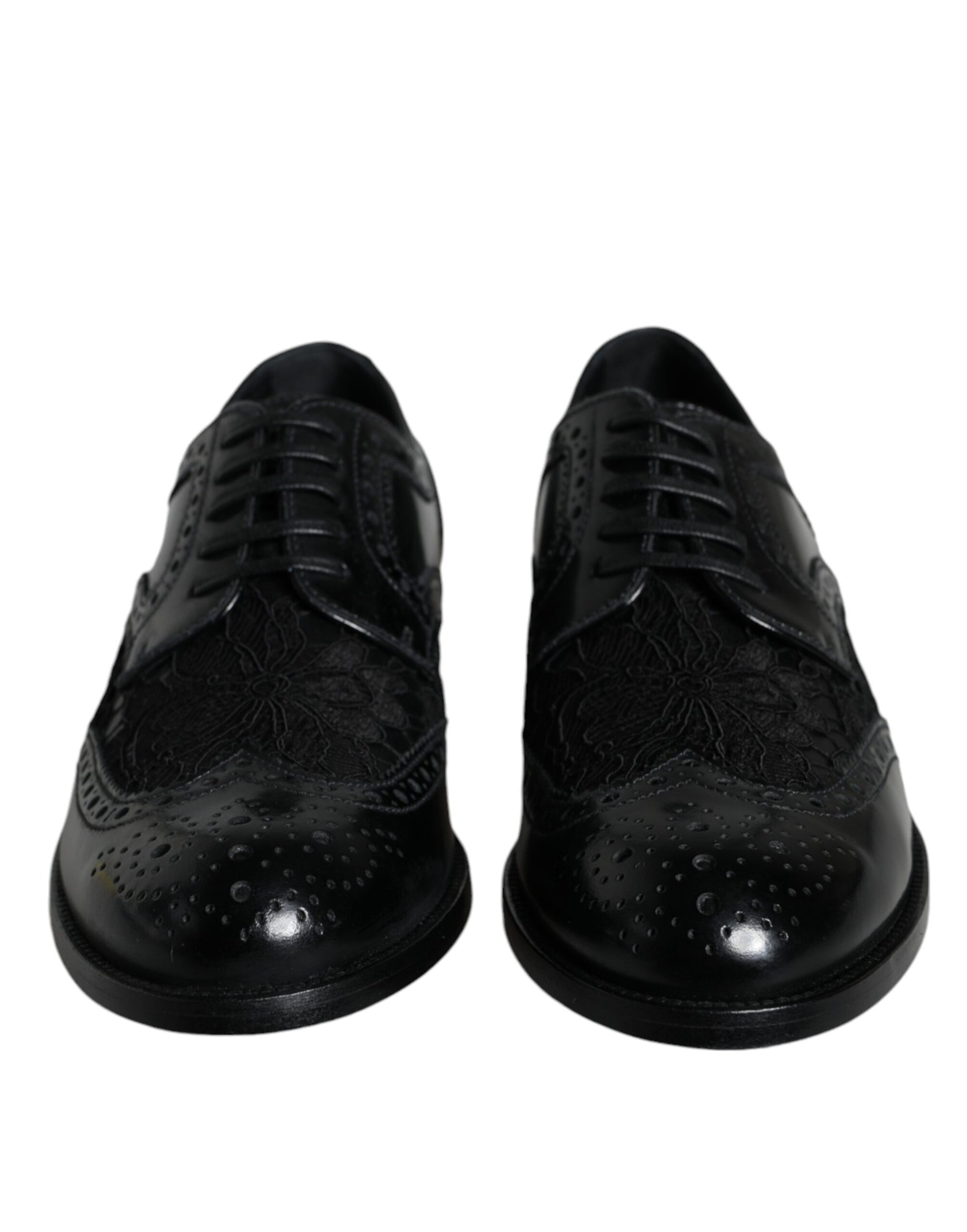 Pair of black leather dress shoes with floral lace design and shiny toe cap