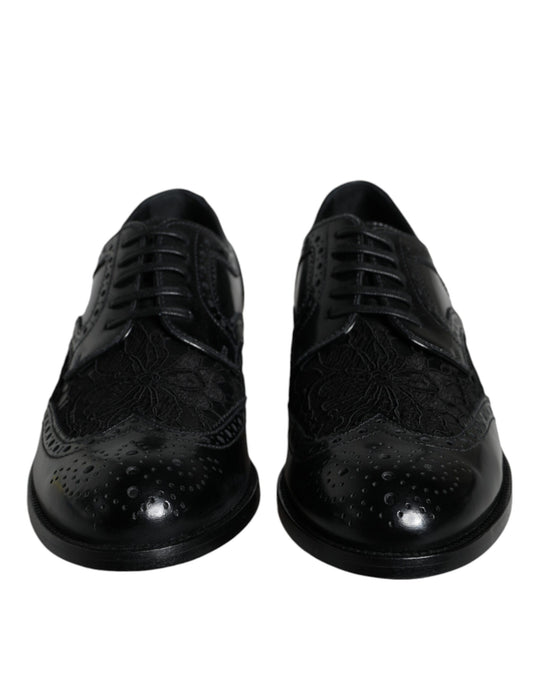 Pair of black leather dress shoes with floral lace design and shiny toe cap