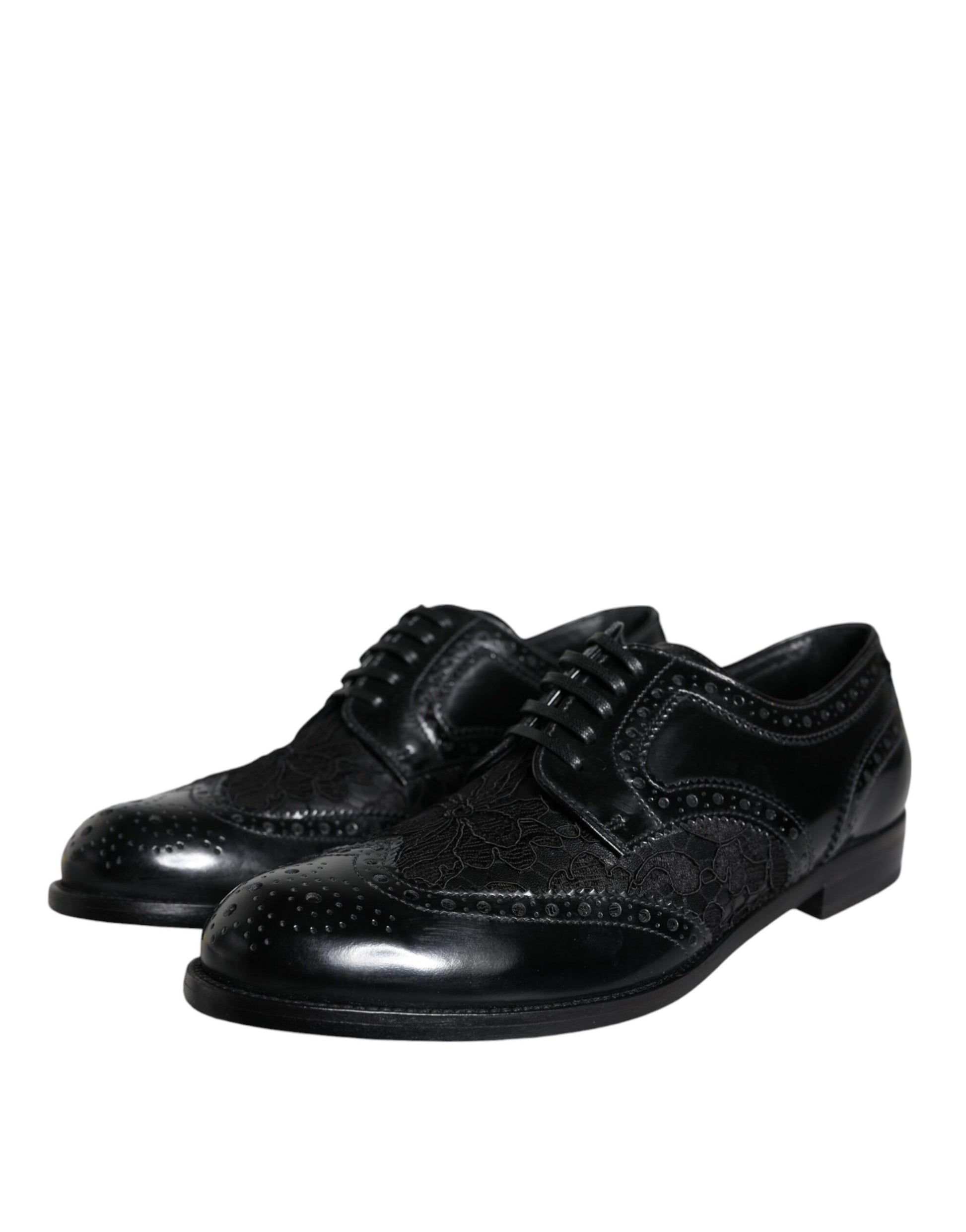 Pair of black leather dress shoes with floral lace design and silver buckles