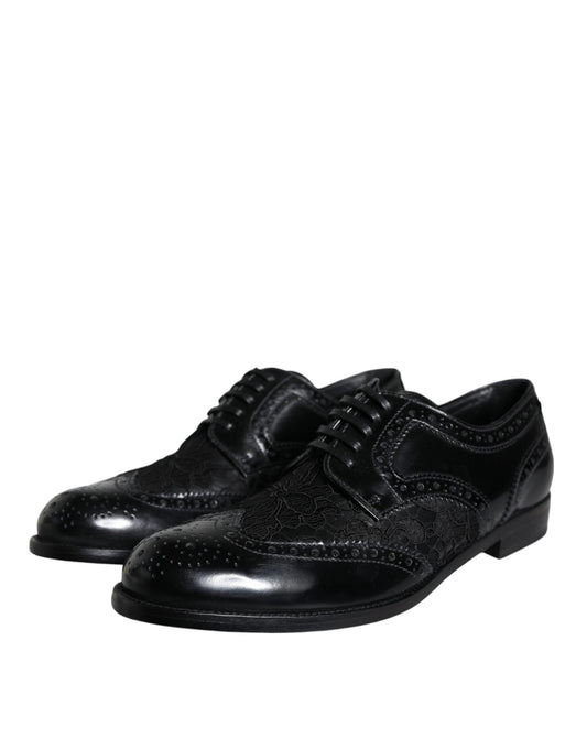 Pair of black leather dress shoes with floral lace design and silver buckles