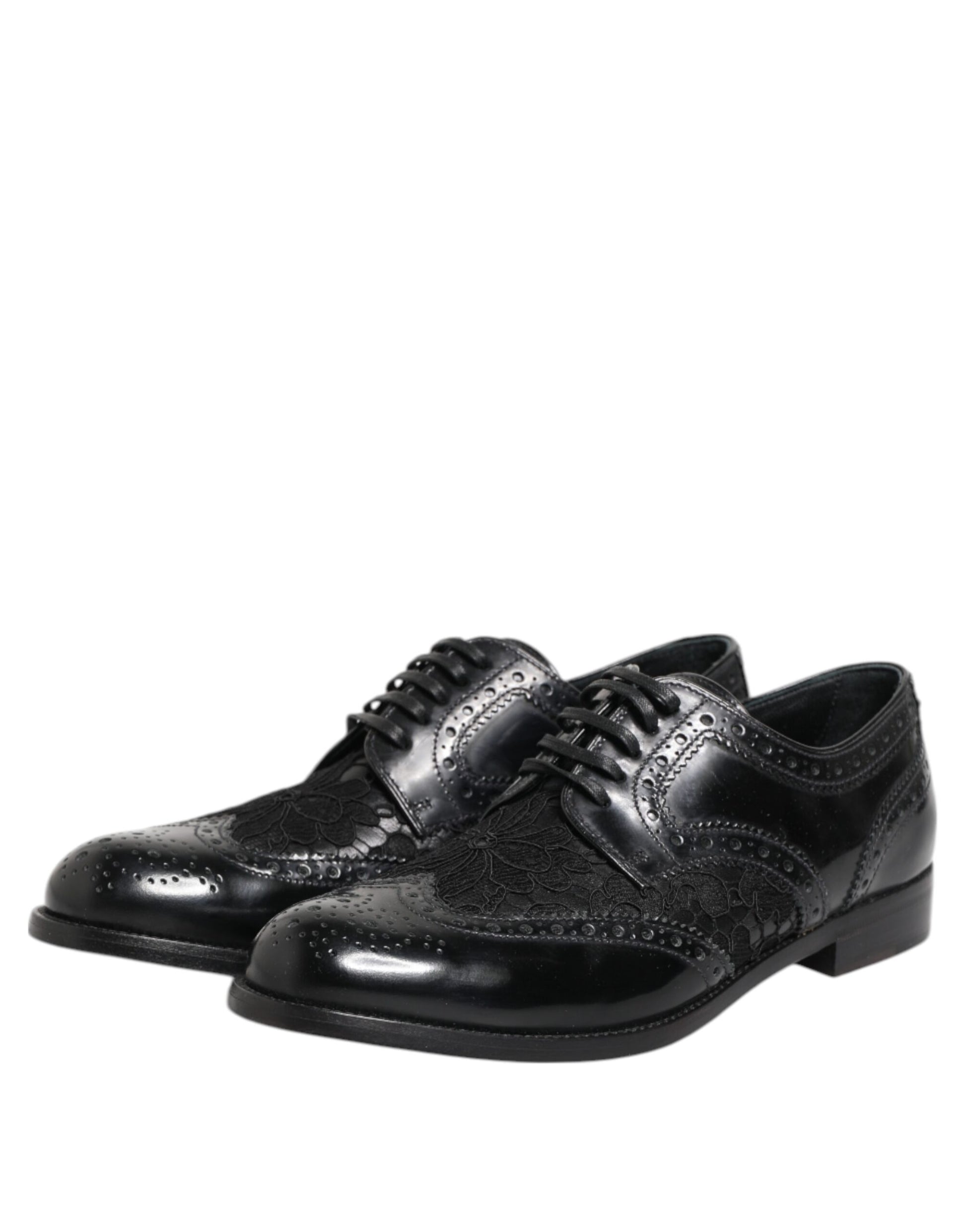 Pair of black leather shoes with floral lace design and silver buckles