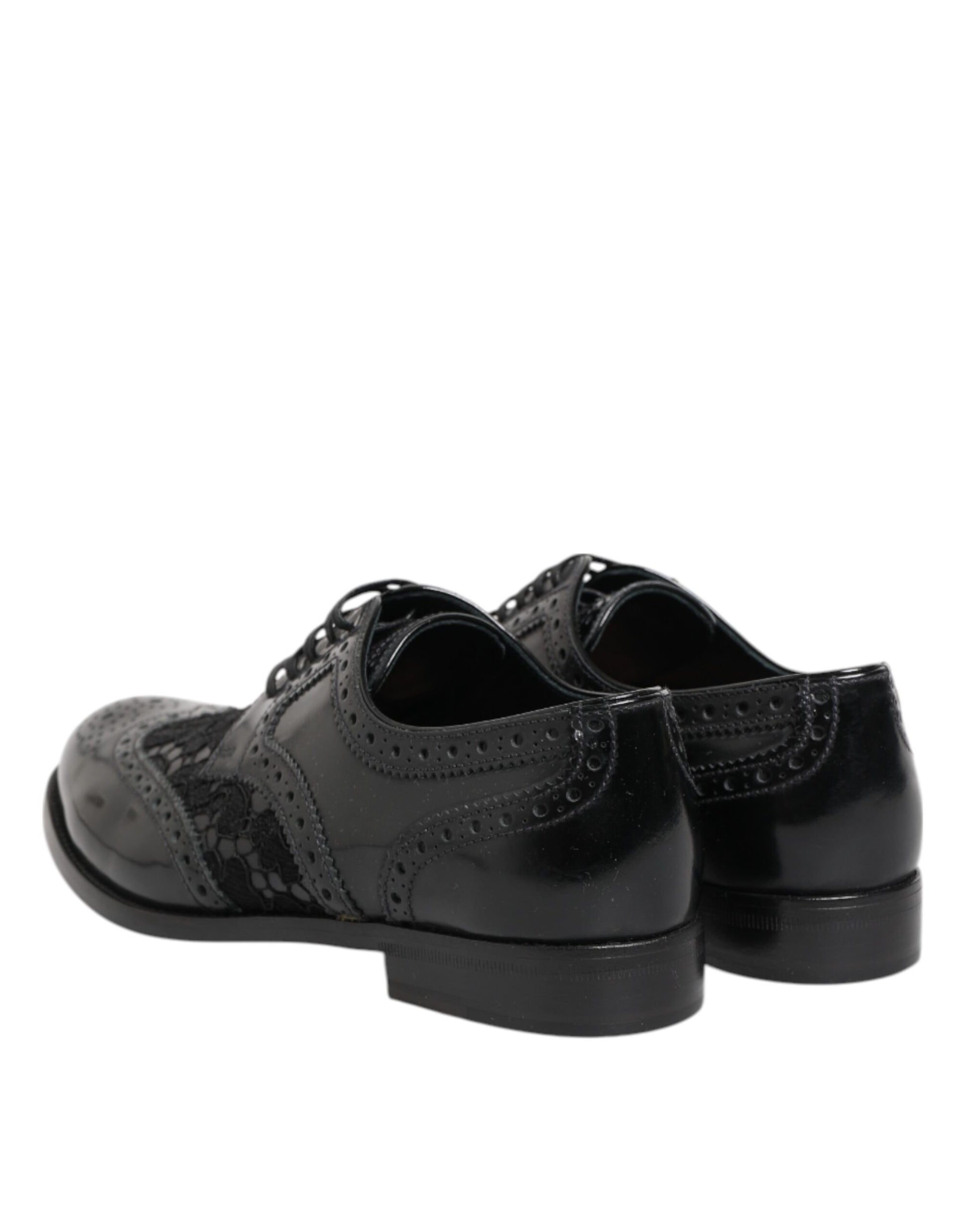Pair of black leather dress shoes with floral lace design and chunky heel